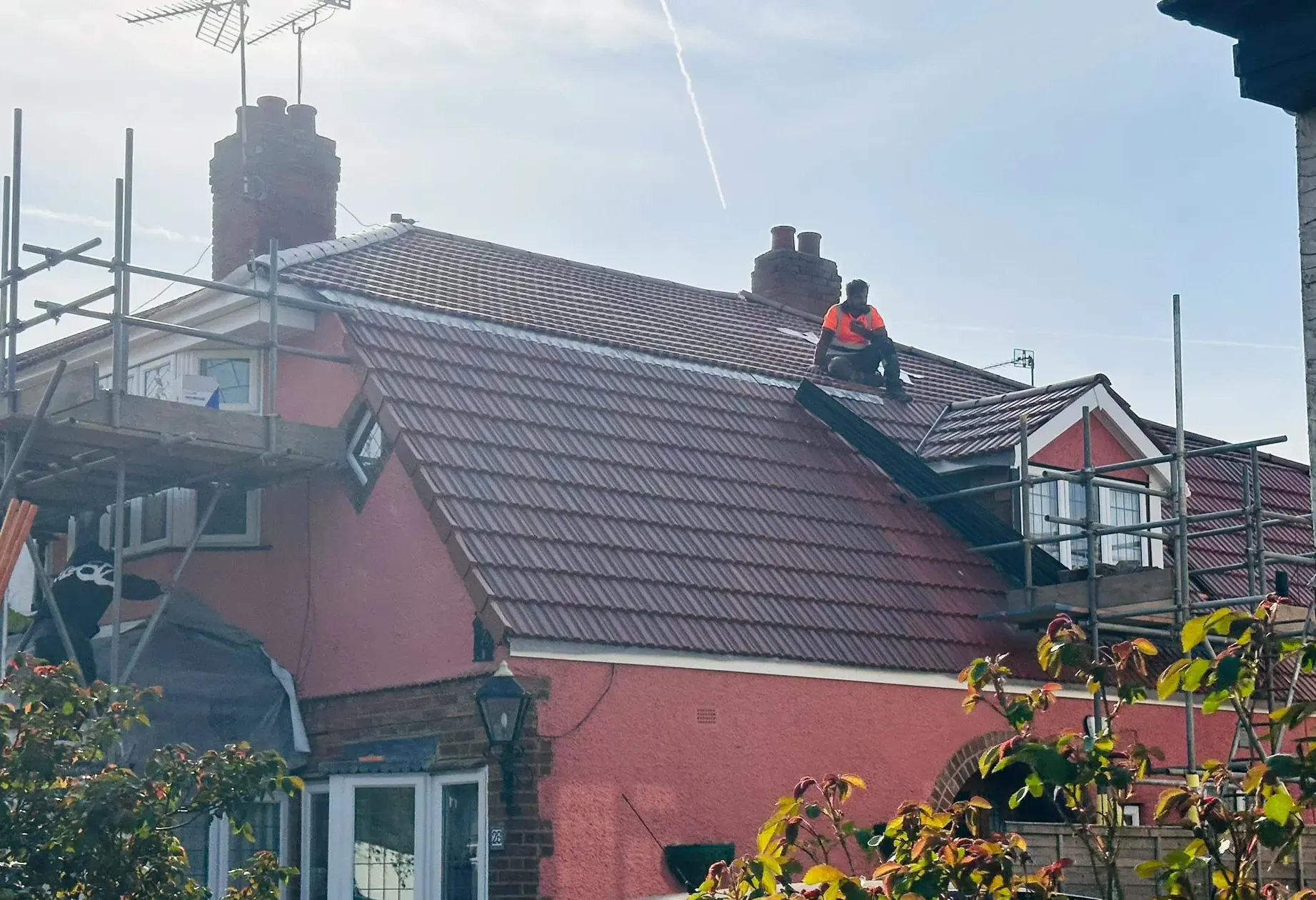Tiled pitched roof on a house in Bracknell, Berkshire, with scaffolding still in place