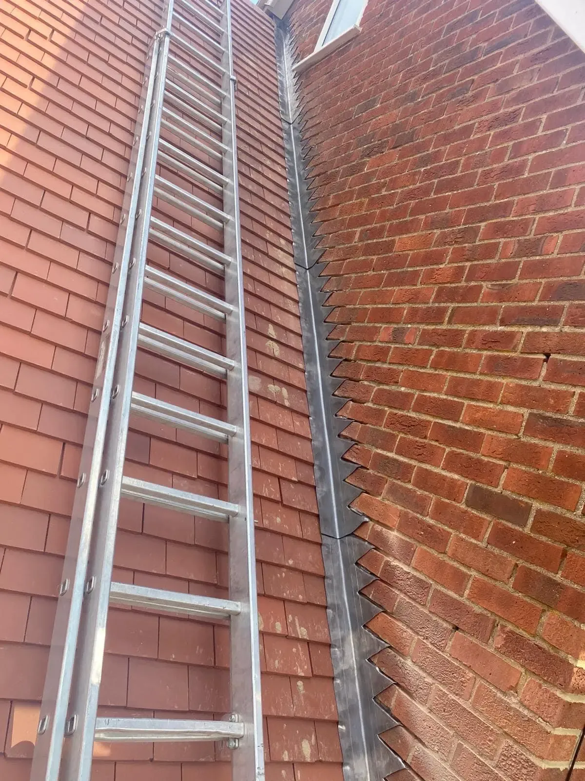 Lead flashing at a roof-to-wall abutment on a tiled roof